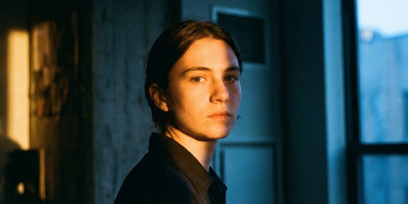 Why are Geminis so two-faced and fake — expressive person with a complex, shifting expression in dramatic split lighting, dual tones suggesting duality